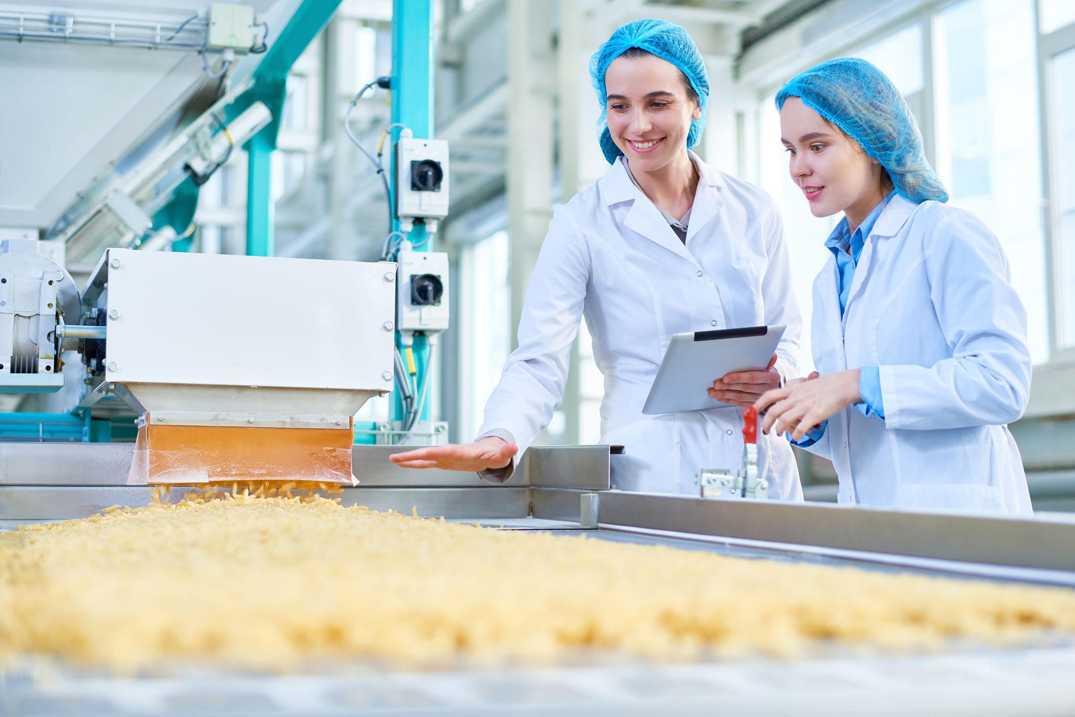 two female food engineers looking at production